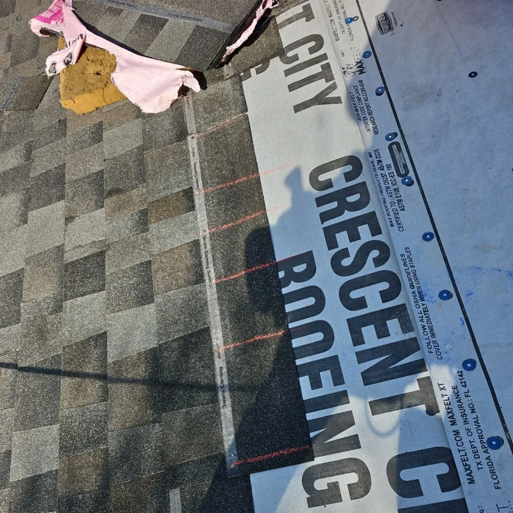 Crescent City Roofing installs MaxFelt XT underlayment beside Owens Corning Williamsburg Gray architectural shingles on large Fortified roof replacement, Lakeview LA.