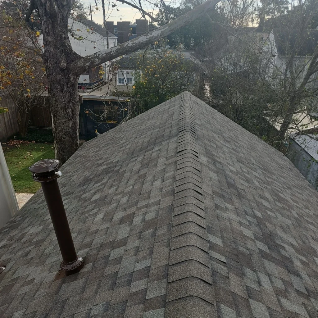 Fortified roof replacement with Owens Corning Driftwood architectural shingles, ridge vent, and pipe boot on historic New Orleans property.