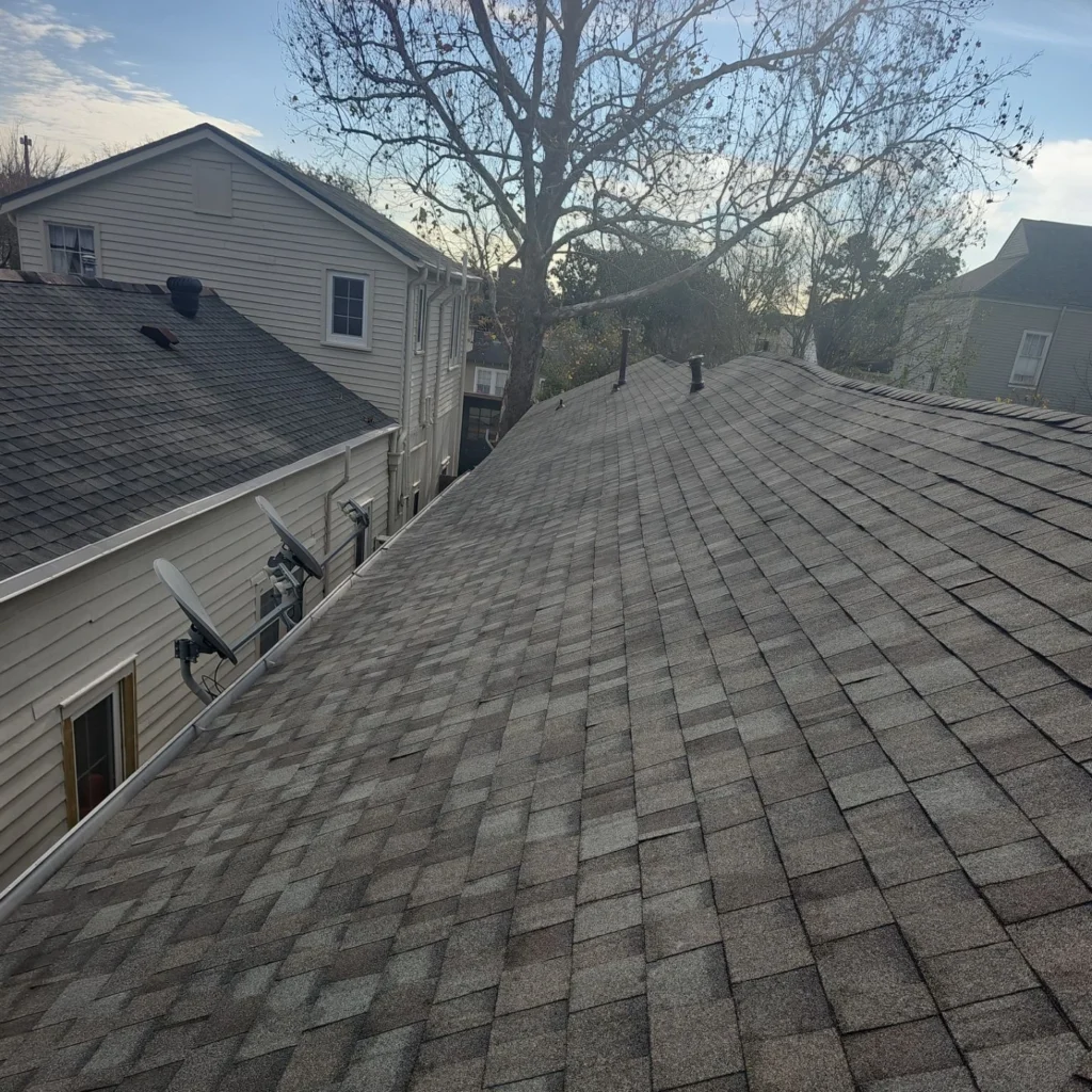 Fortified roof replacement with Owens Corning Driftwood architectural shingles on historic French Quarter home, ridge vents visible