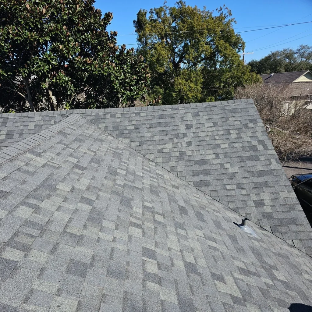 Gray architectural shingles on completed FORTIFIED roof replacement with hip valleys and pipe boot vent, Kenner residential home