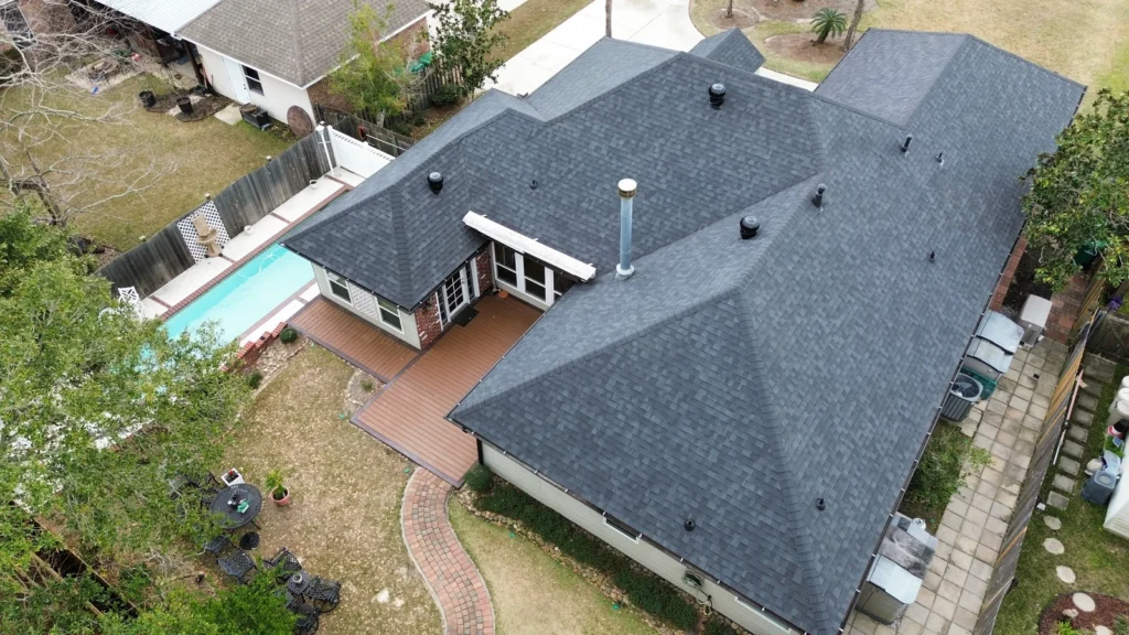 Aerial view of large residential roof replacement with Owens Corning Onyx Black architectural shingles, multiple roof vents, Slidell LA