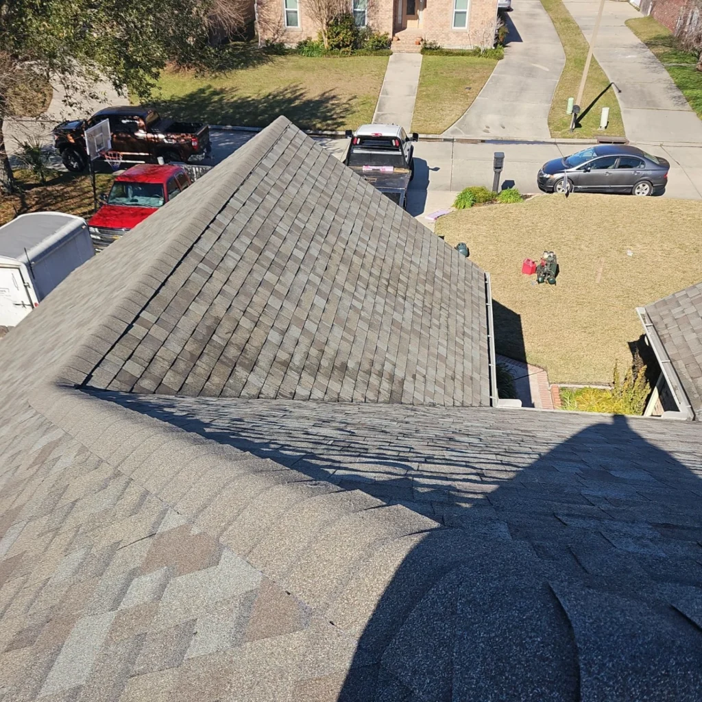 Aerial view of completed FORTIFIED roof replacement with Owens Corning Driftwood architectural shingles on suburban two-story home.