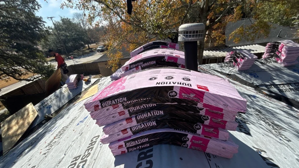 Stacked Owens Corning Duration shingle bundles on underlayment-covered roof deck during residential replacement in Slidell