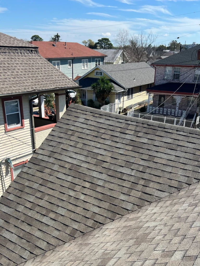 Large residential roof replacement with Owens Corning Driftwood architectural shingles, urban neighborhood setting, Kenner LA.