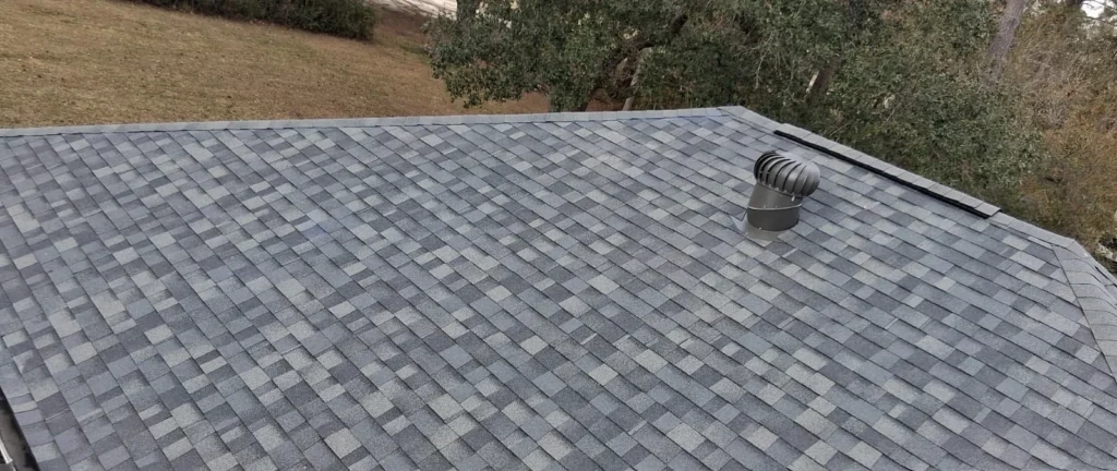 Large residential roof replacement with Owens Corning Estate Gray architectural shingles and turbine vent, Slidell home