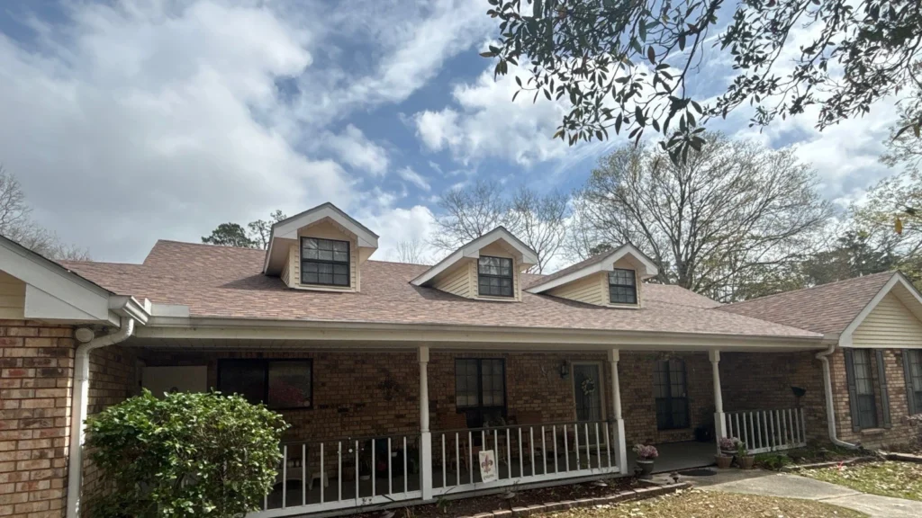 Brick ranch home with new OC Desert Rose shingle FORTIFIED roof replacement, three dormers, white front porch, Slidell LA