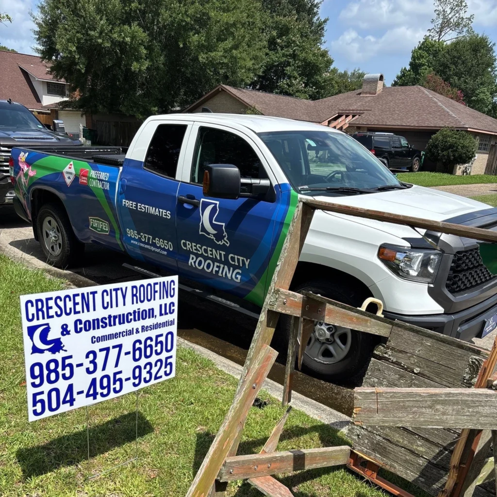 Crescent City Roofing truck and yard sign at Slidell home with completed OC Williamsburg Gray shingle roof replacement.