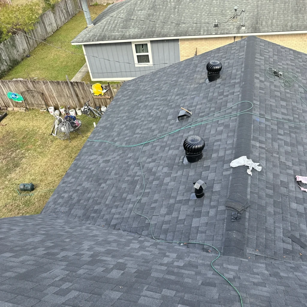 New dark charcoal OC Onyx Black asphalt shingle FORTIFIED roof replacement with turbine vents on large Slidell home